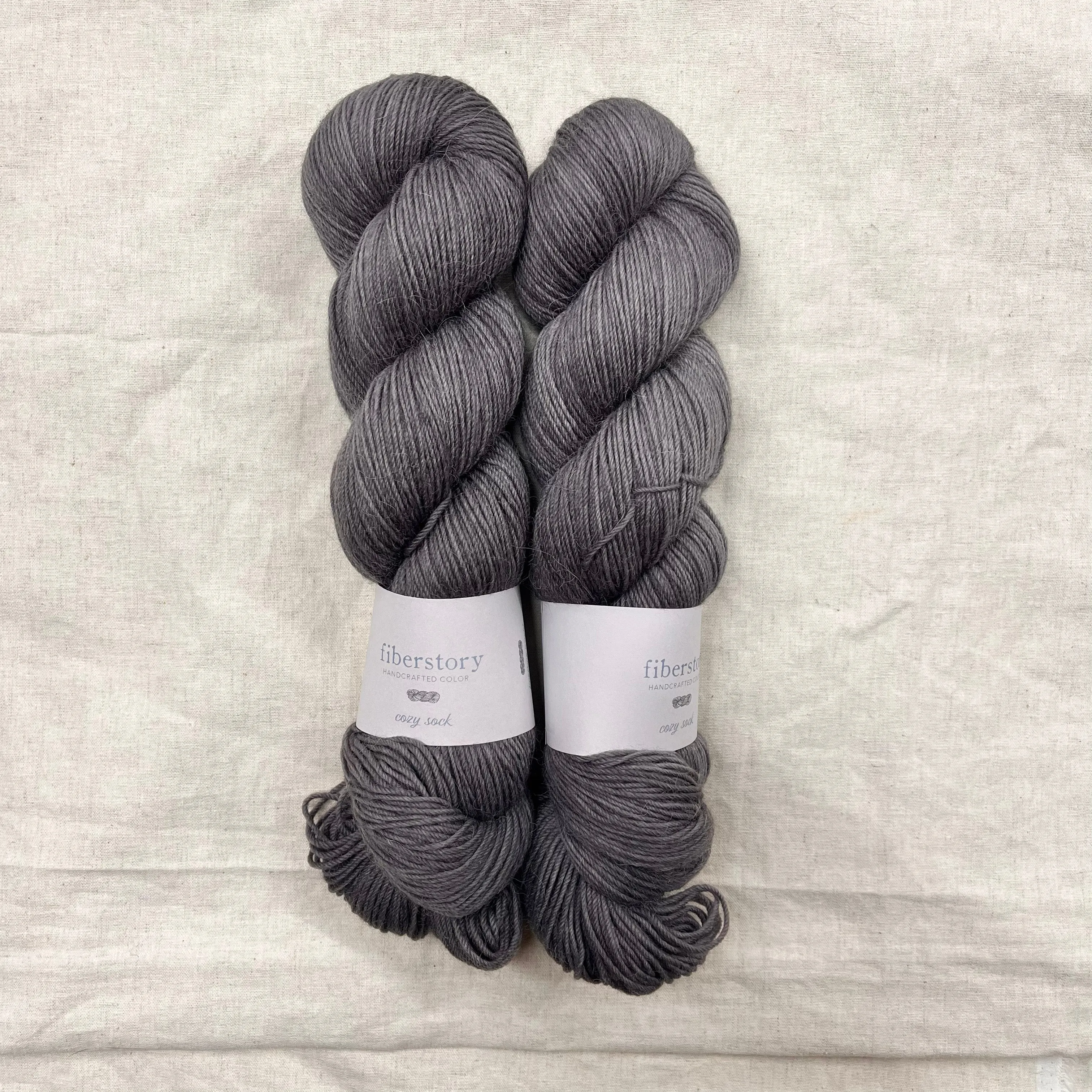 Here is an optimized title for the e-commerce product:

Luxurious Fiberstory Cozy Sock Yarn - Soft, Durable, Hand-Dyed Wool Blend for Knitting & Crochet