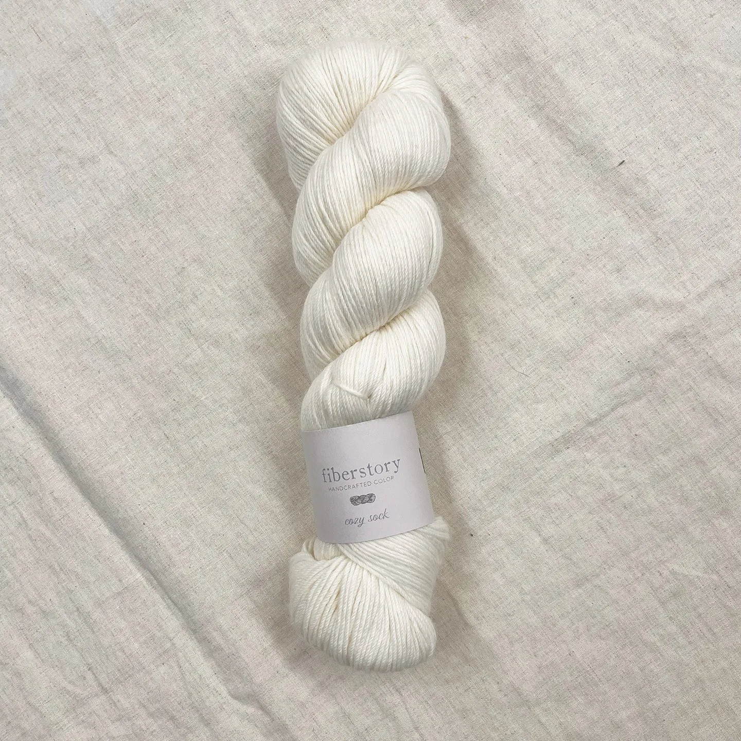 Here is an optimized title for the e-commerce product:

Luxurious Fiberstory Cozy Sock Yarn - Soft, Durable, Hand-Dyed Wool Blend for Knitting & Crochet