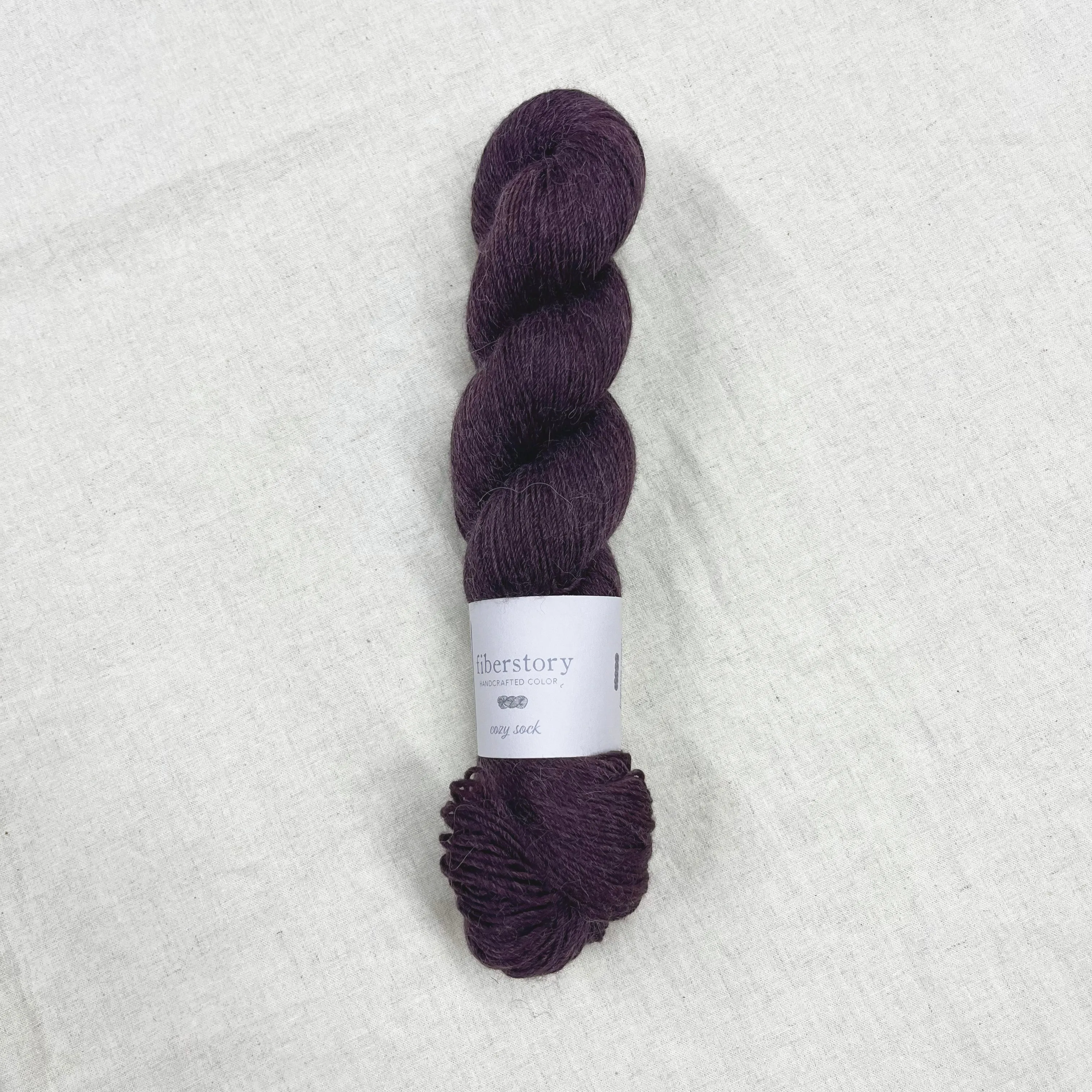 Here is an optimized title for the e-commerce product:

Luxurious Fiberstory Cozy Sock Yarn - Soft, Durable, Hand-Dyed Wool Blend for Knitting & Crochet