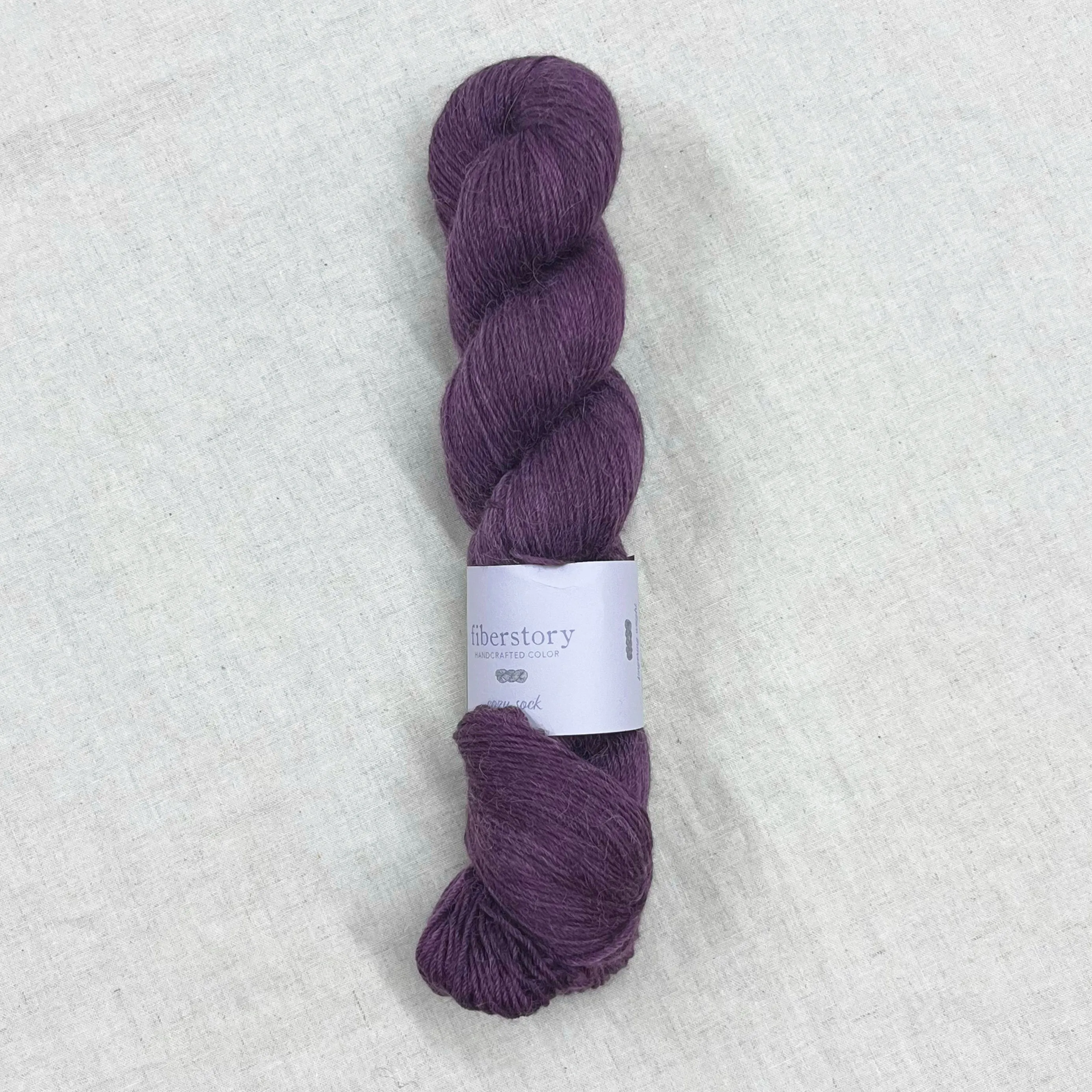 Here is an optimized title for the e-commerce product:

Luxurious Fiberstory Cozy Sock Yarn - Soft, Durable, Hand-Dyed Wool Blend for Knitting & Crochet